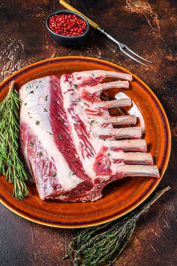 Raw Racks of Lamb Ready for Cooking. Dark Background. Top View Stock
