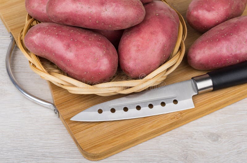 Raw Red Potato in Wicker Basket and Kitchen Knife Stock Photo Image