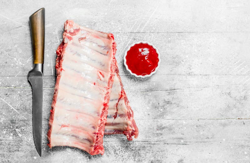 Raw ribs with tomato sauce stock photo. Image of barbecue 141862468