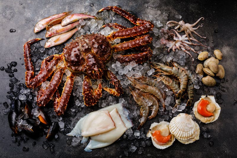 Raw Seafood on ice - King Crab, Prawn Shrimp, Clams, Scallops, Octopus, Squ...