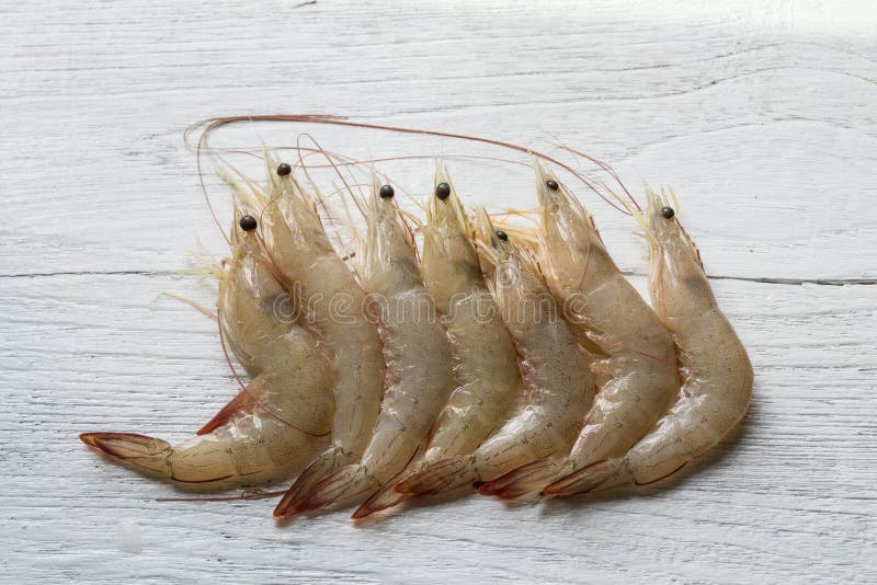 Raw shrimp on white wooden