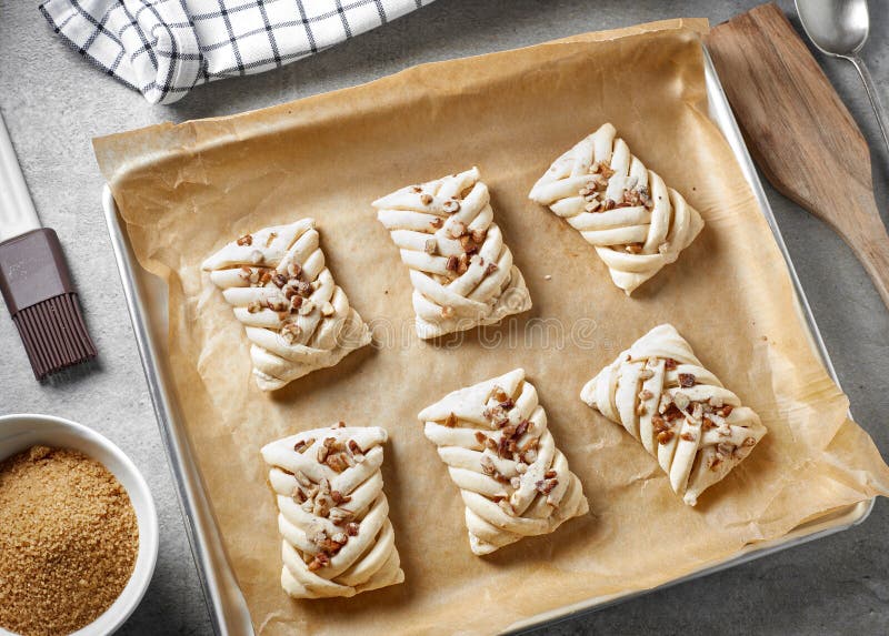 Raw sweet buns on baking pan