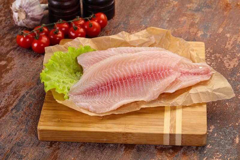 Raw tilapia fish stock image. Image of cooking, thyme 197573091