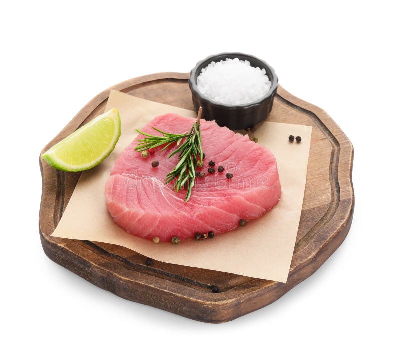 Raw Tuna Fillet with Spices and Lime Wedge on White Background Stock