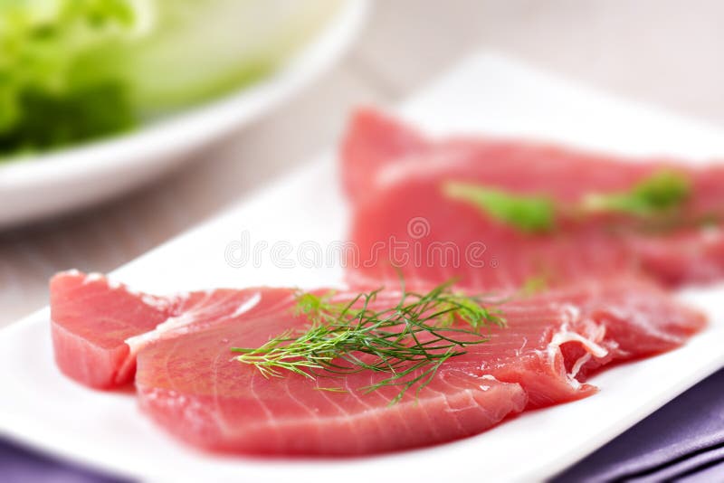 Raw Tuna steak. Raw fish on a plate royalty free stock image