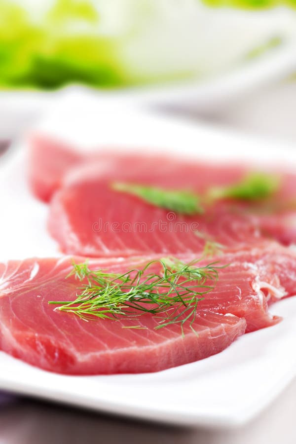 Raw Tuna steak. Raw fish on a plate royalty free stock image