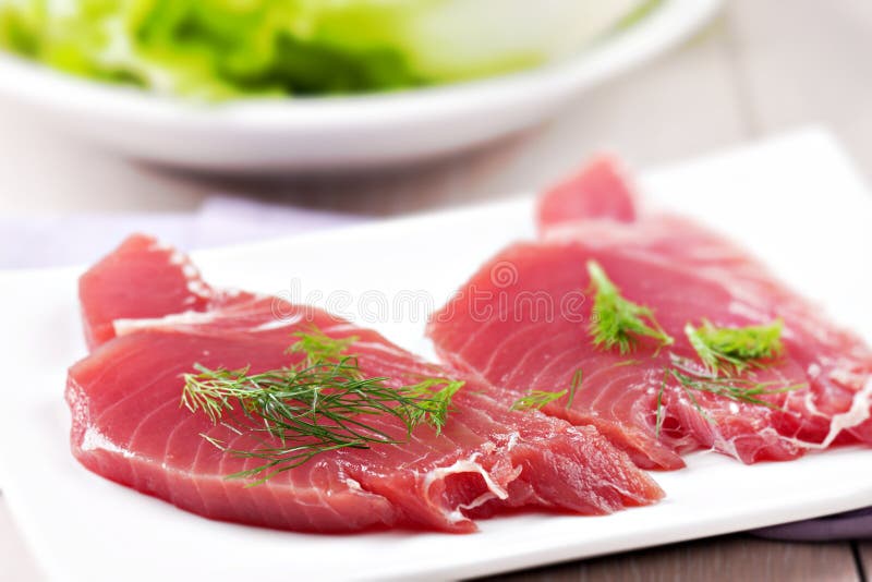Raw Tuna steak. Raw fish on a plate royalty free stock images
