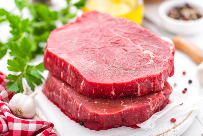 Raw, Uncooked Beef Meat Steaks on White Wooden Background Stock Image