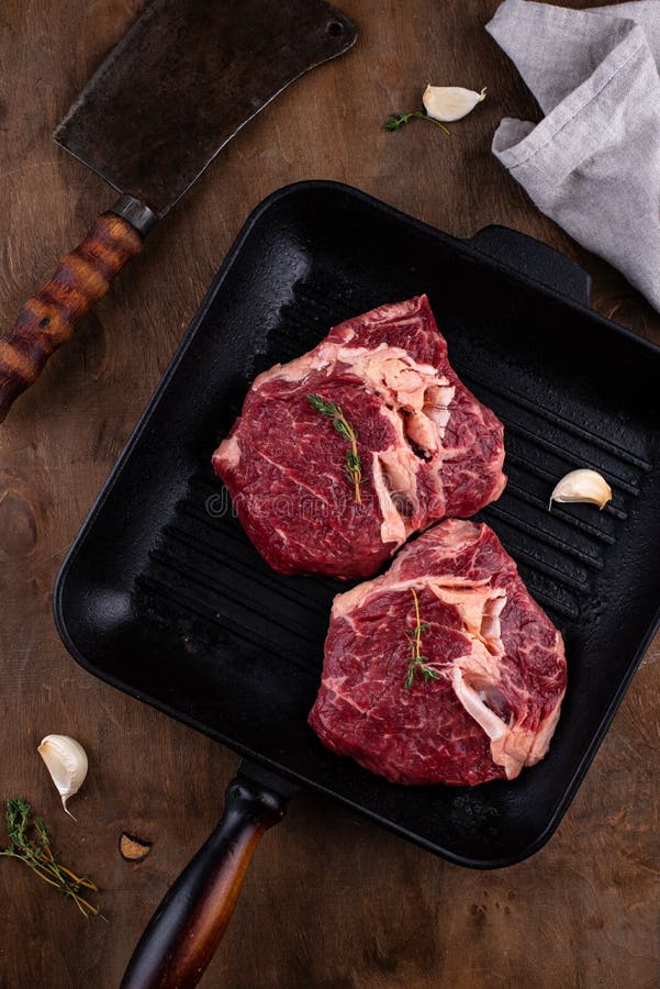 Raw uncooked rib eye steak stock photo. Image of beef 219046462