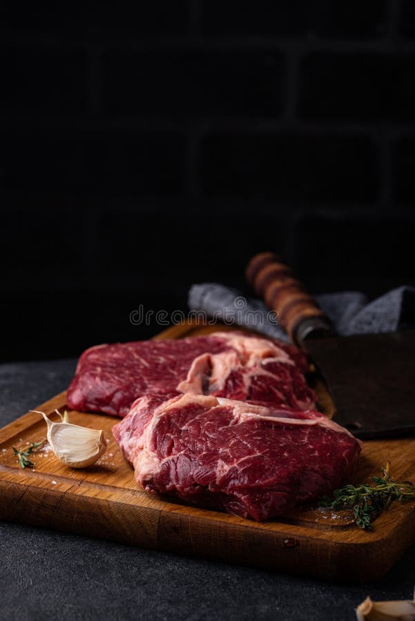 Raw uncooked rib eye steak stock image. Image of herbs 222788483