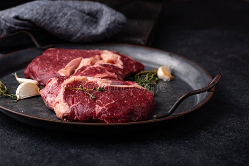 Raw uncooked rib eye steak stock photo. Image of food 222788812
