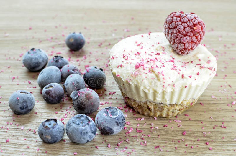 Raw vegan ice cream muffin with blueberries and raspberry. Vegetarian royalty free stock images
