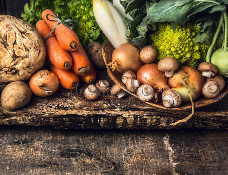 Raw vegetables and edible root various on dark wooden rustic background