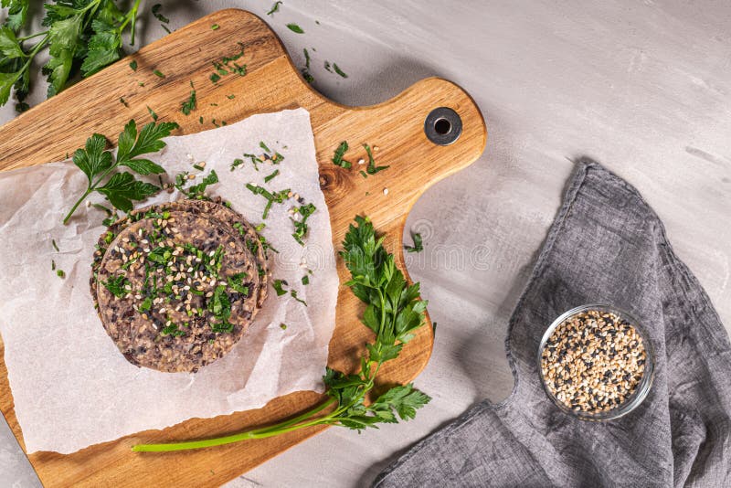 Raw Veggie Burger With Black Beans On Wood Countertop Stock Image