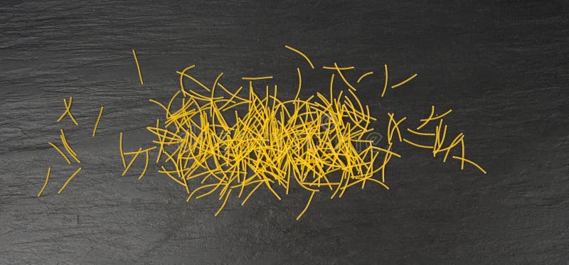 Raw vermicelli, gold soup pasta, small scattered homemade noodles, thin macaroni royalty free stock image