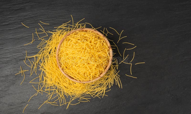 Raw vermicelli, gold soup pasta, small scattered homemade noodles, thin macaroni royalty free stock images