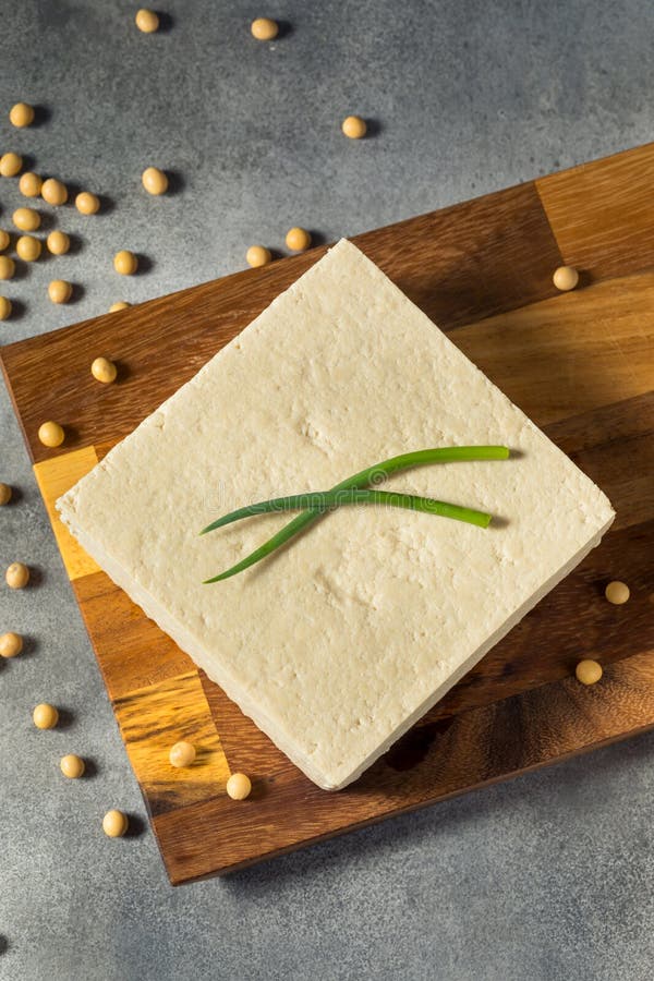 Firm Tofu on a Chopping Board with shape cutter Stock Photo - Alamy