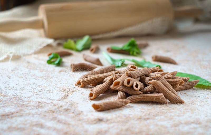 Raw Wholegrain Pasta Homemade on the Table with Flour Stock Image