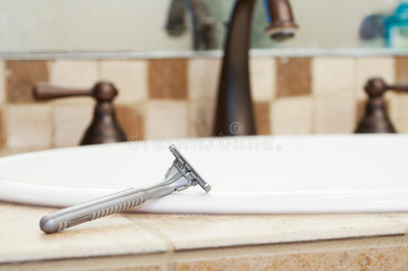 Razor Resting On Edge Of Sink In Bathroom Stock Photo Image of bath, sink 31017646