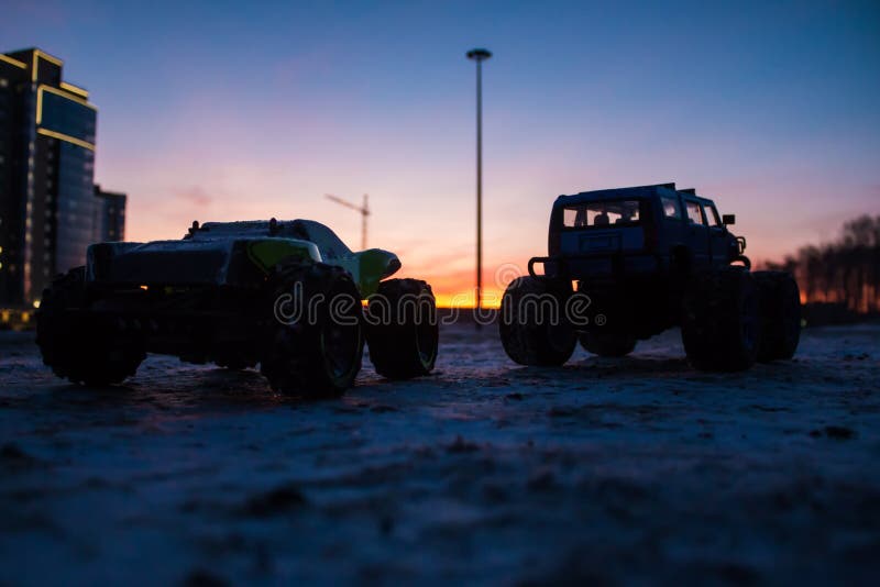 RC car monster trucks at sunset of the day. RC car monster trucks at sunset of the day