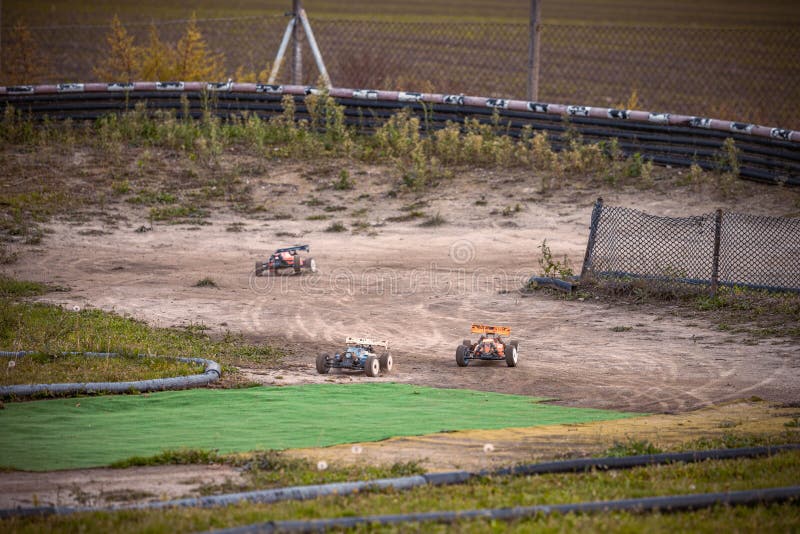 3 RC buggies racing on an outdoor track