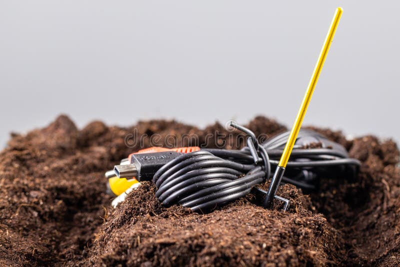 The RCA Jack Cable is Buried in the Ground Like a Grave. Stock Photo