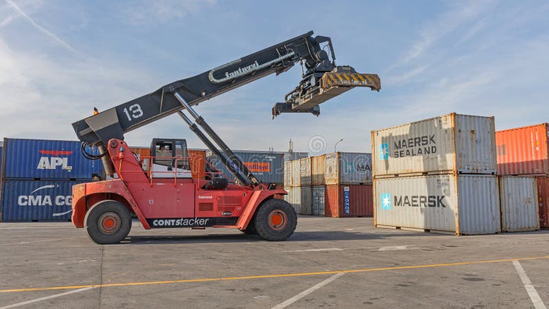 Dobanovci,Serbia - March 3,2017: Reach Stacker Lifting Shipping Container at Cargo Terminal.