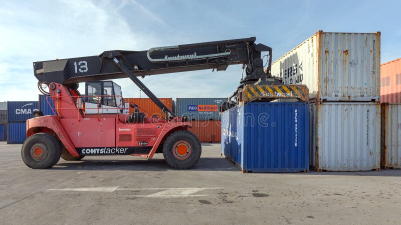 Dobanovci,Serbia - March 3,2017: Reach Stacker Lifting Shipping Container at Cargo Terminal Yard.