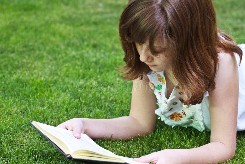 Read.Young beautiful girl reading a book outdoor