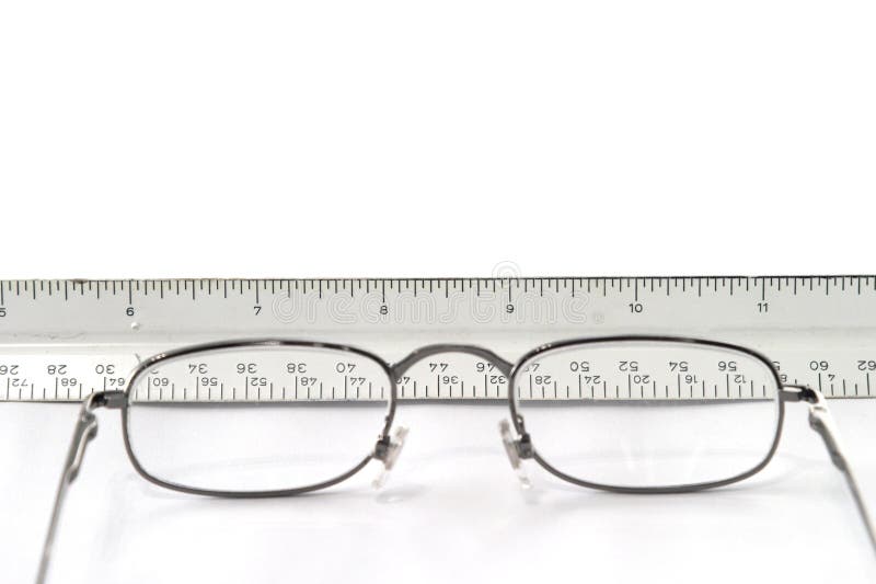 Reading Eyeglasses On Table With View Of Ruler Through Glasses Stock