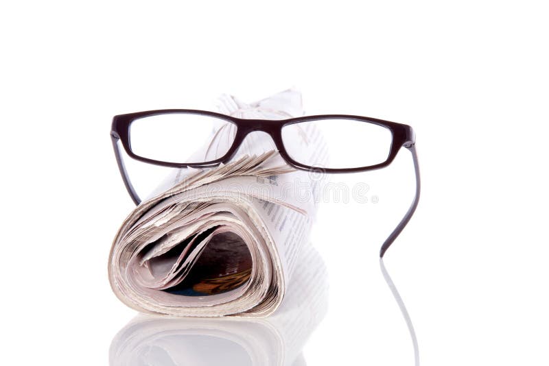 Reading glasses on newspaper