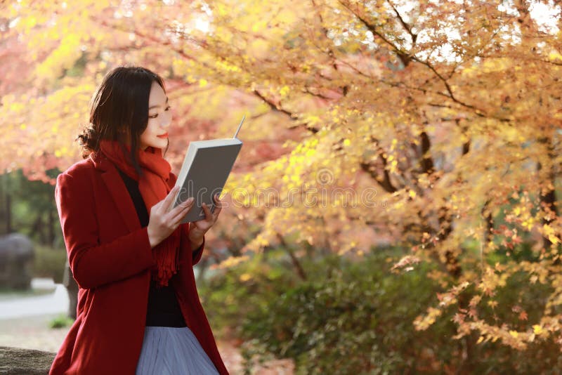 Reading in nature is my hobby, beautiful girl Read book sit on stone in park