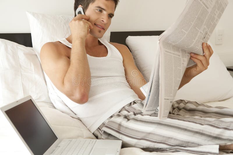 Young professional working from home in bedroom. Reading efficiency stock images, royalty-free photos and pictures