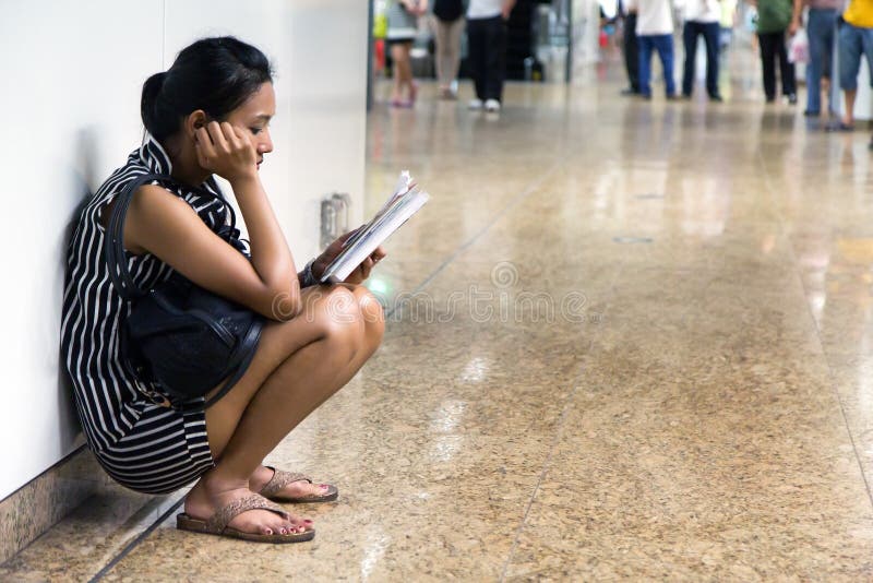 Reading woman in the lobby stock photo