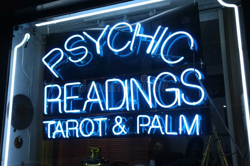 A neon sign that says Psychic Readings Tarot & Palm. A neon sign that says Psychic Readings Tarot & Palm.
