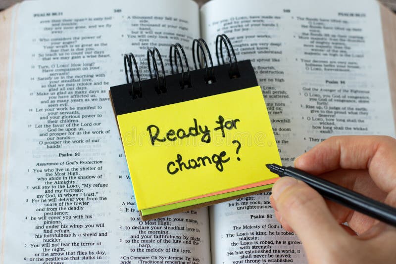 \ Ready for change\ , a handwritten text message on a yellow note on top of an open Holy Bible Book