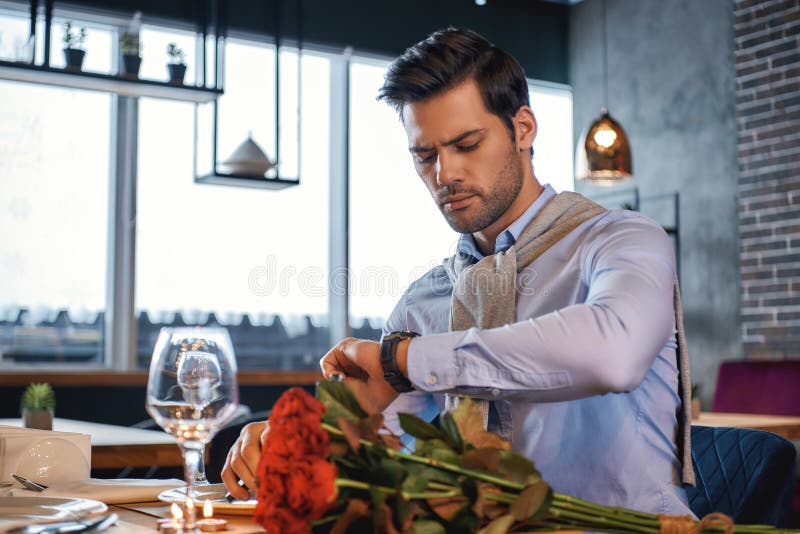 Ready to meet you. Romantic man is waiting for his date in restaurant