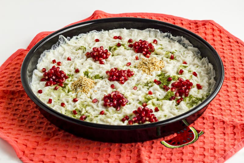 Ready to serve Traditional Turkish Ramadan Dessert; Gullac is in black tray on the kitchen cloth. Close-up taken of Traditional Turkish Ramadan Dessert `Gullac stock photo Ready to serve Traditional Turkish Ramadan Dessert; Gullac is in black tray on the kitchen cloth. Close-up taken of Traditional Turkish Ramadan Dessert `Gullac stock photo