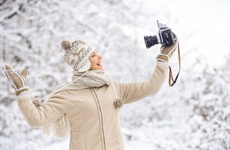 Ready for weather forecast. expedition. winter girl with vintage camera. happy woman make selfie on camera. winter royalty free stock photo Ready for weather forecast. expedition. winter girl with vintage camera. happy woman make selfie on camera. winter royalty free stock photo