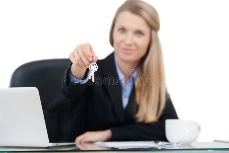 Focus on the keys. A real estate agent giving you keys to your new home. Isolated on white background. Focus on the keys. A real estate agent giving you keys to your new home. Isolated on white background.