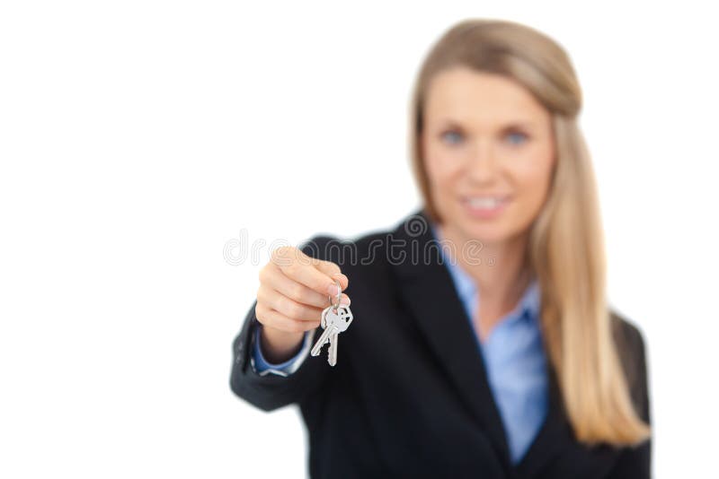 Focus on the keys. A real estate agent giving you keys to your new home. Isolated on white background. Focus on the keys. A real estate agent giving you keys to your new home. Isolated on white background.