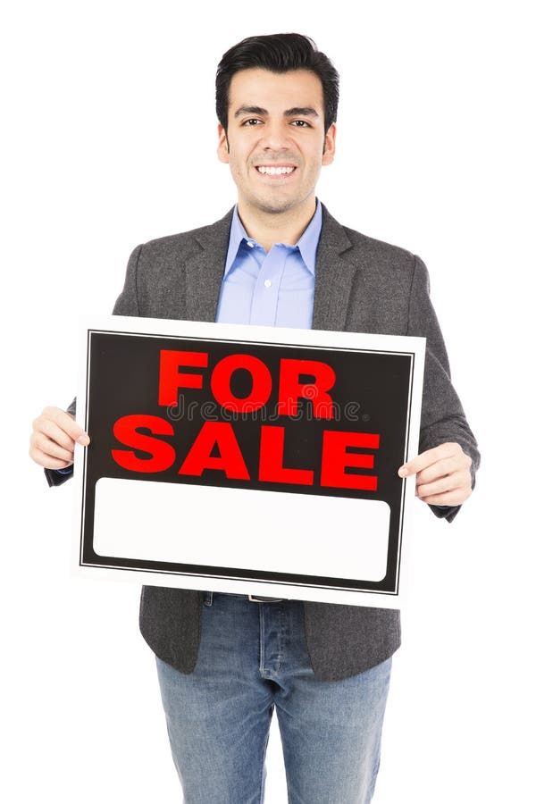 Hispanic real estate agent holding a for sale sign isolated on white background. Hispanic real estate agent holding a for sale sign isolated on white background