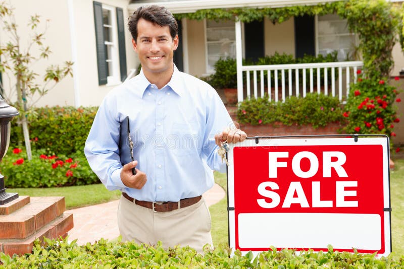 Real estate agent standing outside house stock photography Real estate agent standing outside house stock photography