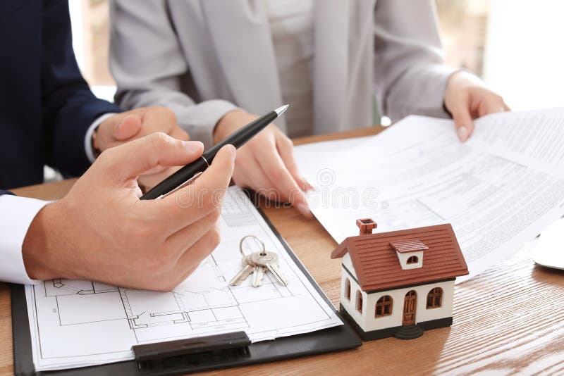 Real estate agent working with client in office royalty free stock photos Real estate agent working with client in office royalty free stock photos
