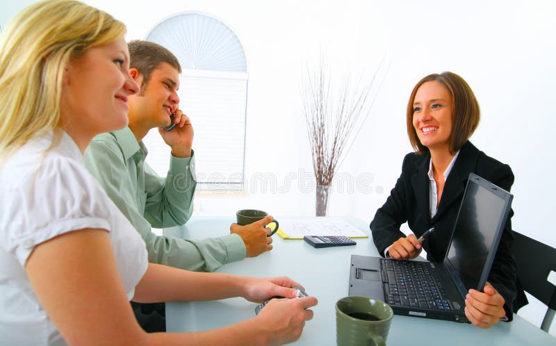 Real Estate Broker Showing Laptop To Clients