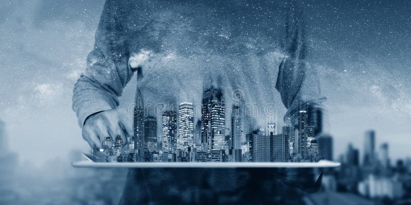 Real estate business and investment, building technology. a man using digital tablet with buildings hologram stock image Real estate business and investment, building technology. a man using digital tablet with buildings hologram stock image