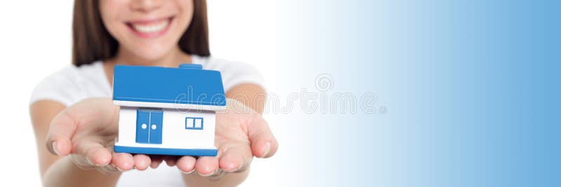 Real estate house banner with blue copy space panorama. Woman smiling showing miniature toy home holding hands for home stock images Real estate house banner with blue copy space panorama. Woman smiling showing miniature toy home holding hands for home stock images