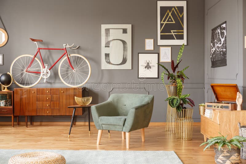 Real photo of a green armchair on wooden floor, old-fashioned si