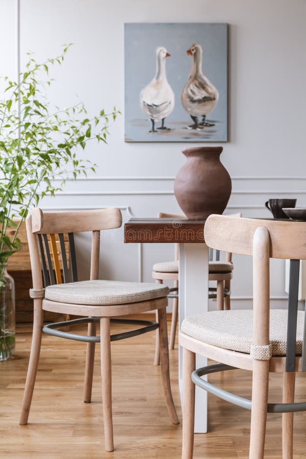Real photo of a natural daily room interior with chairs, table, clay vase and painting with ducks stock image Real photo of a natural daily room interior with chairs, table, clay vase and painting with ducks stock image