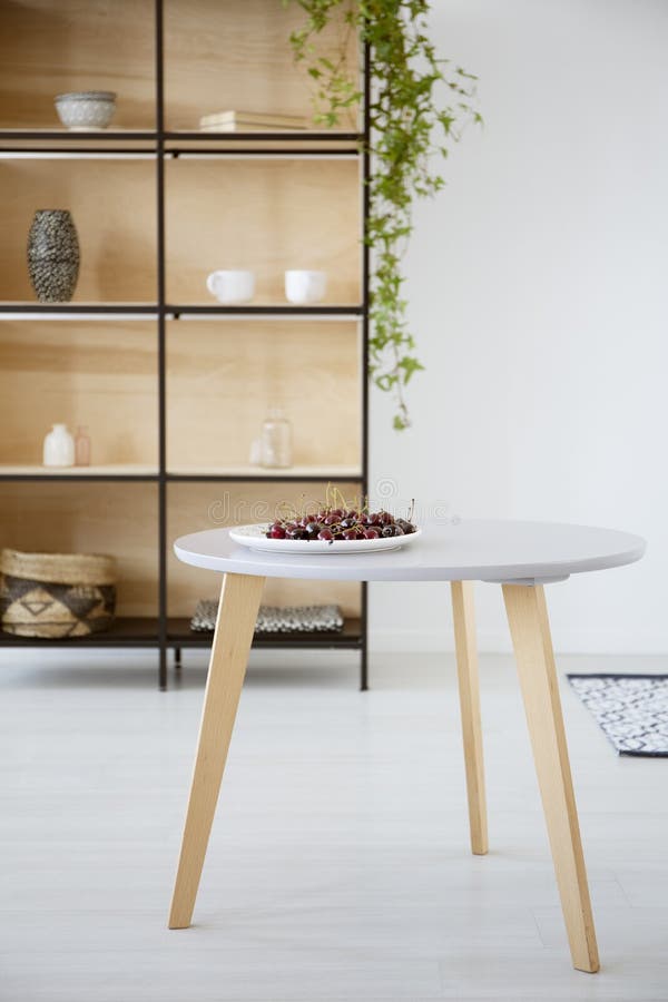 Real photo of a plate of cherries on a round, wooden table in br stock images Real photo of a plate of cherries on a round, wooden table in br stock images
